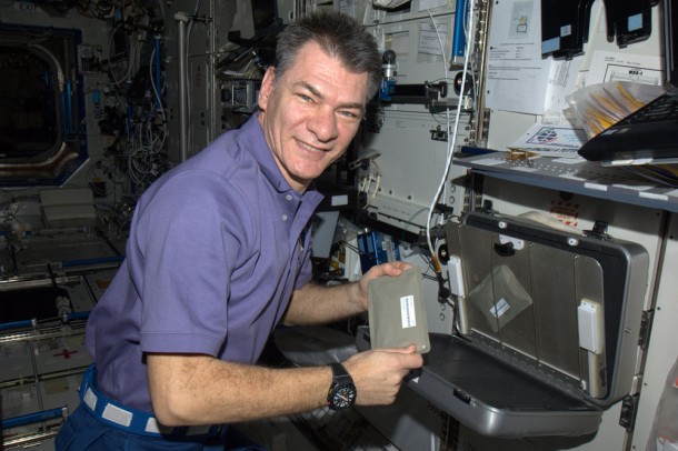 Paolo Nespoli shows a food warmer on ISS   Credits: ESA/NASA