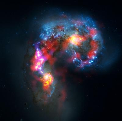 The Antennae Galaxies (also known as NGC 4038 and 4039) are a pair of distorted colliding spiral galaxies about 70 million light-years away, in the constellation of Corvus (The Crow). This view combines ALMA observations, made in two different wavelength ranges during the observatory's early testing phase, with visible-light observations from the NASA/ESA Hubble Space Telescope. Credit: ALMA (ESO/NAOJ/NRAO). Visible light image: the NASA/ESA Hubble Space Telescope The Antennae Galaxies (also known as NGC 4038 and 4039) are a pair of distorted colliding spiral galaxies about 70 million light-years away, in the constellation of Corvus (The Crow). This view combines ALMA observations, made in two different wavelength ranges during the observatory's early testing phase, with visible-light observations from the NASA/ESA Hubble Space Telescope. Credit: ALMA (ESO/NAOJ/NRAO). Visible light image: the NASA/ESA Hubble Space Telescope