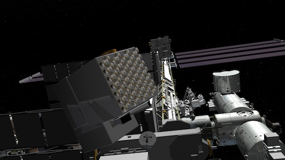 This is an artist's concept of the NICER instrument on board the International Space Station. NICER is the cube in the foreground on the left. The circular objects protruding from the cube are telescopes that focus X-rays from the pulsar on to the detector. Credit: NASA This is an artist's concept of the NICER instrument on board the International Space Station. NICER is the cube in the foreground on the left. The circular objects protruding from the cube are telescopes that focus X-rays from the pulsar on to the detector. Credit: NASA