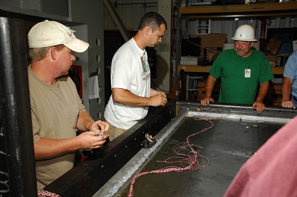From left, Jeremy Kelly, Wes Lawler and Dani Davis, all Lockheed Martin Corp. test personnel, perform tests on the Orion manufacturing development article shear panel. (NASA/MSFC) From left, Jeremy Kelly, Wes Lawler and Dani Davis, all Lockheed Martin Corp. test personnel, perform tests on the Orion manufacturing development article shear panel. (NASA/MSFC)