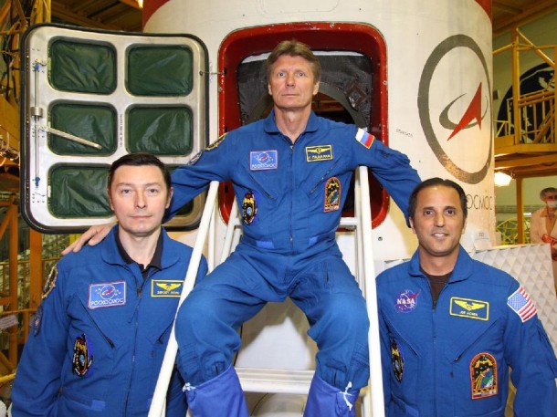 The next trio of crew members bound for the International Space Station pose in front of the hatchway to their Soyuz TMA-04M spacecraft as they completed their final "fit check" inspection of the vehicle. Photo credit: NASA/Victor Zelentsov The next trio of crew members bound for the International Space Station pose in front of the hatchway to their Soyuz TMA-04M spacecraft as they completed their final "fit check" inspection of the vehicle. Photo credit: NASA/Victor Zelentsov