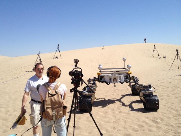 Michael Malin, left, principal investigator for three science cameras on NASA's Curiosity Mars rover, comments to a news reporter during tests with Curiosity's mobility-test stand-in, Scarecrow, on Dumont Dunes in California's Mojave Desert. Image credit: NASA/JPL-Caltech Michael Malin, left, principal investigator for three science cameras on NASA's Curiosity Mars rover, comments to a news reporter during tests with Curiosity's mobility-test stand-in, Scarecrow, on Dumont Dunes in California's Mojave Desert. Image credit: NASA/JPL-Caltech