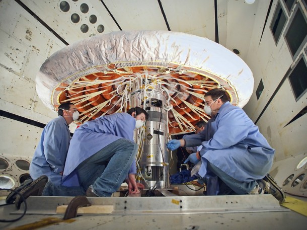 Engineers checked out the Inflatable Reentry Vehicle Experiment after the successful completion of an inflation system test. The IRVE-3 is scheduled to launch on a sounding rocket later this summer. Credit: NASA/ Sean Smith Engineers checked out the Inflatable Reentry Vehicle Experiment after the successful completion of an inflation system test. The IRVE-3 is scheduled to launch on a sounding rocket later this summer. Credit: NASA/ Sean Smith