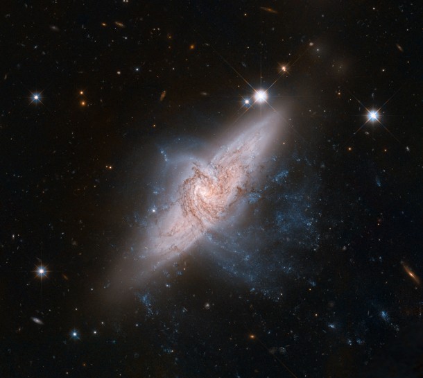 The NASA/ESA Hubble Space Telescope has produced an incredibly detailed image of a pair of overlapping galaxies called NGC 3314. While the two galaxies look as if they are in the midst of a collision, this is in fact a trick of perspective: the two are in chance alignment from our vantage point. Credit: NASA, ESA, the Hubble Heritage Team (STScI/AURA)-ESA/Hubble Collaboration, and W. Keel (University of Alabama) The NASA/ESA Hubble Space Telescope has produced an incredibly detailed image of a pair of overlapping galaxies called NGC 3314. While the two galaxies look as if they are in the midst of a collision, this is in fact a trick of perspective: the two are in chance alignment from our vantage point. Credit: NASA, ESA, the Hubble Heritage Team (STScI/AURA)-ESA/Hubble Collaboration, and W. Keel (University of Alabama)