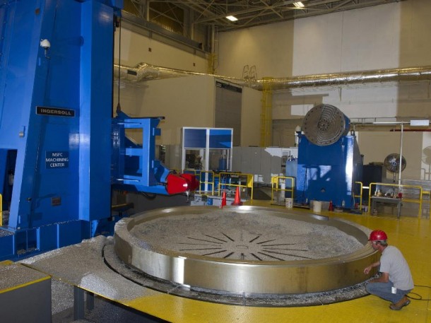 A Marshall Center machinist takes a close look at a recent cut on an aluminum adapter ring. (NASA/MSFC) A Marshall Center machinist takes a close look at a recent cut on an aluminum adapter ring. (NASA/MSFC)