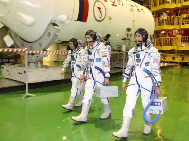 At the Baikonur Cosmodrome in Kazakhstan, Expedition 32 Flight Engineers Aki Hoshide (left), Yuri Malenchenko (center) and Suni Williams walk by the upper stage of their Soyuz booster rocket. Credit: NASA/Victor Zelentsov At the Baikonur Cosmodrome in Kazakhstan, Expedition 32 Flight Engineers Aki Hoshide (left), Yuri Malenchenko (center) and Suni Williams walk by the upper stage of their Soyuz booster rocket. Credit: NASA/Victor Zelentsov