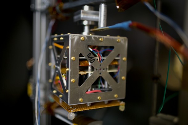 A magnetically levitated small satellite inside a vacuum chamber simulates space-like conditions to test the performance of mini ion thrusters in the laboratory. Photo: M. Scott Brauer A magnetically levitated small satellite inside a vacuum chamber simulates space-like conditions to test the performance of mini ion thrusters in the laboratory. Photo: M. Scott Brauer