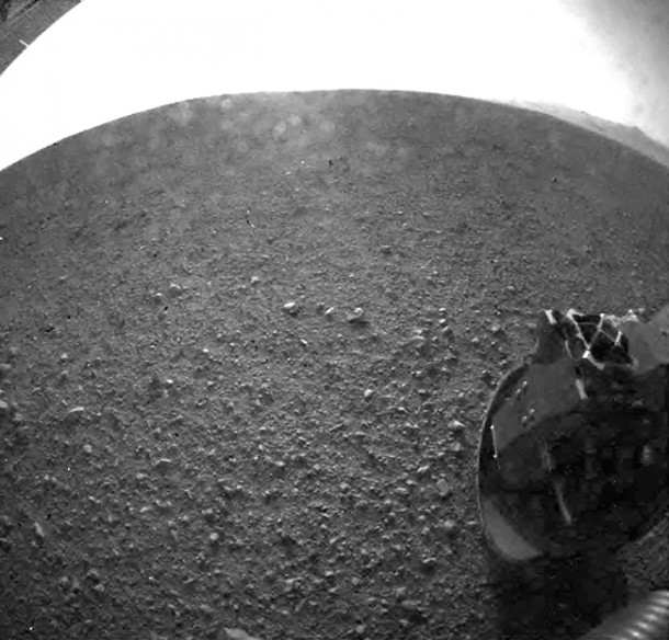 This image shows one of the first views from NASA's Curiosity rover, which landed on Mars the evening of Aug. 5 PDT (early morning hours Aug. 6 EDT). It was taken through a "fisheye" wide-angle lens on one of the rover's Hazard-Avoidance cameras. These engineering cameras are located at the rover's base. As planned, the early images are lower resolution. Larger color images are expected later in the week when the rover's mast, carrying high-resolution cameras, is deployed. Image credit: NASA/JPL-Caltech This image shows one of the first views from NASA's Curiosity rover, which landed on Mars the evening of Aug. 5 PDT (early morning hours Aug. 6 EDT). It was taken through a "fisheye" wide-angle lens on one of the rover's Hazard-Avoidance cameras. These engineering cameras are located at the rover's base. As planned, the early images are lower resolution. Larger color images are expected later in the week when the rover's mast, carrying high-resolution cameras, is deployed. Image credit: NASA/JPL-Caltech
