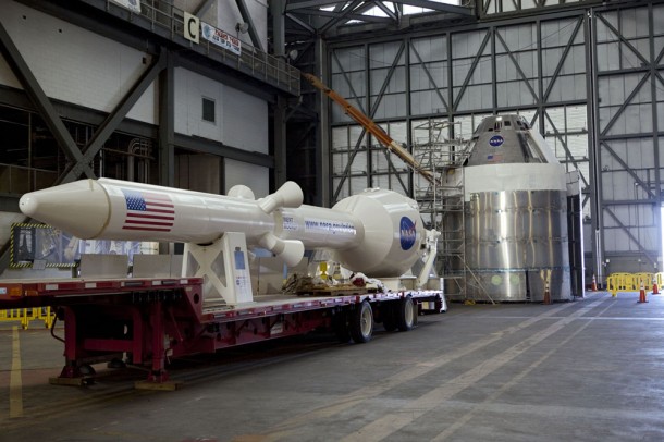 The mockup components of an Orion spacecraft are laid out in the transfer aisle of the Vehicle Assembly Building at NASA's Kennedy Space Center in Florida. In the foreground is the Launch Abort System, then the aerodynamic shell that will cover the capsule. To the right is the Orion capsule model on top of a service module simulator. All are the exact dimensions the flight-ready Orions will be. Photo credit: NASA/Dmitri Gerondidakis The mockup components of an Orion spacecraft are laid out in the transfer aisle of the Vehicle Assembly Building at NASA's Kennedy Space Center in Florida. In the foreground is the Launch Abort System, then the aerodynamic shell that will cover the capsule. To the right is the Orion capsule model on top of a service module simulator. All are the exact dimensions the flight-ready Orions will be. Photo credit: NASA/Dmitri Gerondidakis