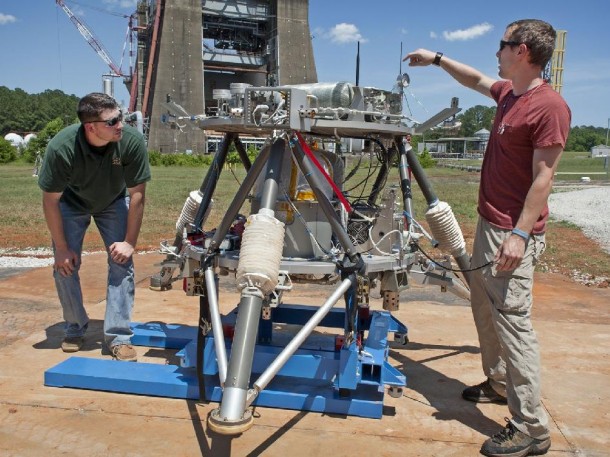 Marshall Center engineers Logan Kennedy, right, and Adam Lacock check out the lander prototype, dubbed the "Mighty Eagle." (NASA/MSFC/Fred Deaton) Marshall Center engineers Logan Kennedy, right, and Adam Lacock check out the lander prototype, dubbed the "Mighty Eagle." (NASA/MSFC/Fred Deaton)