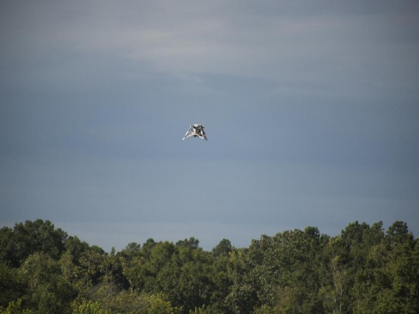 The "Mighty Eagle" soars above the tree line. The vehicle was "open loop" -- navigating autonomously without the command of the onboard camera and flying on a preprogrammed flight profile. (NASA/MSFC/Fred Deaton) The "Mighty Eagle" soars above the tree line. The vehicle was "open loop" -- navigating autonomously without the command of the onboard camera and flying on a preprogrammed flight profile. (NASA/MSFC/Fred Deaton)