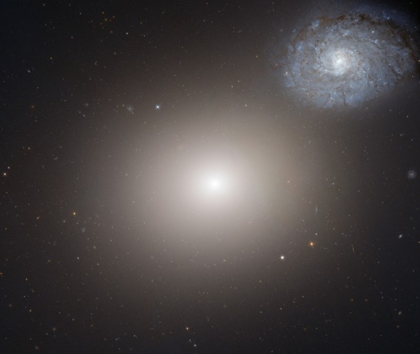 The galaxy pair Arp 116. The faint bluish spiral galaxy NGC 4647 is much lower in mass and about two thirds the size of Messier 60, which occupies the center of this image. NGC4647 is roughly the size of our galaxy, the Milky Way. (Credit: NASA/ESA) The galaxy pair Arp 116. The faint bluish spiral galaxy NGC 4647 is much lower in mass and about two thirds the size of Messier 60, which occupies the center of this image. NGC4647 is roughly the size of our galaxy, the Milky Way. (Credit: NASA/ESA)