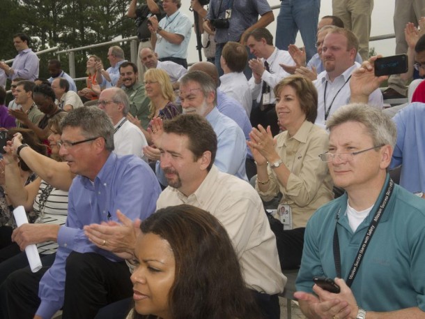 An excited crowd claps and cheers as the "Mighty Eagle" lands after a successful, 100-foot test Sept. 5. Among those watching the test are, Denise Smithers, in foreground, an executive intern supporting the Marshall Center’s acting director and administrative team; second row, from left, Chris Cianciola, manager of Marshall's Human Exploration Development Office; Daniel Schumacher, manager of Marshall's Science & Technology Office; and Johnny Stephenson, deputy director of Marshall's Office of Strategic Analysis & Communications. On the third row, above Schumacher, are from left, Dale Thomas, associate director (technical) in Marshall's Office of the Director; Ellen Ochoa, deputy director of Johnson Space Center in Houston, and a former astronaut; and Jonathan Pettus, acting associate director of Marshall. (NASA/MSFC/Emmett Given) An excited crowd claps and cheers as the "Mighty Eagle" lands after a successful, 100-foot test Sept. 5. Among those watching the test are, Denise Smithers, in foreground, an executive intern supporting the Marshall Center’s acting director and administrative team; second row, from left, Chris Cianciola, manager of Marshall's Human Exploration Development Office; Daniel Schumacher, manager of Marshall's Science & Technology Office; and Johnny Stephenson, deputy director of Marshall's Office of Strategic Analysis & Communications. On the third row, above Schumacher, are from left, Dale Thomas, associate director (technical) in Marshall's Office of the Director; Ellen Ochoa, deputy director of Johnson Space Center in Houston, and a former astronaut; and Jonathan Pettus, acting associate director of Marshall. (NASA/MSFC/Emmett Given)