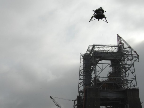 Overcast skies didn't deter the "Mighty Eagle," flying high above the historic F-1 test stand – formerly used to test turbopumps for Saturn first stage engines. (NASA/MSFC/Dennis Olive) Overcast skies didn't deter the "Mighty Eagle," flying high above the historic F-1 test stand – formerly used to test turbopumps for Saturn first stage engines. (NASA/MSFC/Dennis Olive)