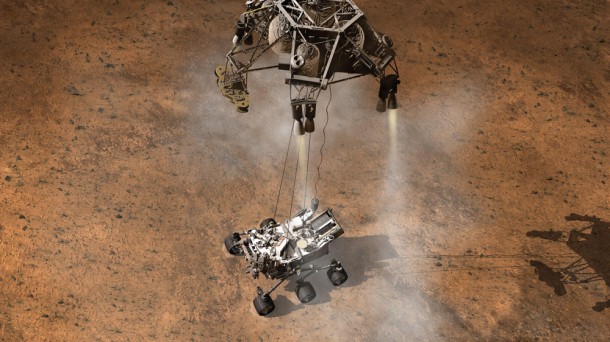 In this artist's rendering, the Mars Science Laboratory's descent stage uses rocket engines to hover, while its sky crane lowers the Curiosity rover with a 25-foot tether to a soft landing on the surface. Photographs show there were some rocks and dust kicked up by the rocket engines on the sky-crane lowering the Curiosity lander onto the Martian surface. Image Credit: NASA/JPL-Caltech In this artist's rendering, the Mars Science Laboratory's descent stage uses rocket engines to hover, while its sky crane lowers the Curiosity rover with a 25-foot tether to a soft landing on the surface. Photographs show there were some rocks and dust kicked up by the rocket engines on the sky-crane lowering the Curiosity lander onto the Martian surface. Image Credit: NASA/JPL-Caltech