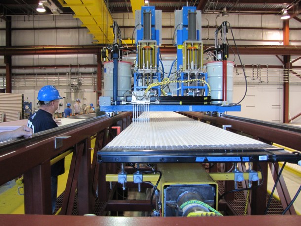 Technicians glue modules using a machine developed at Argonne National Laboratory. Photo by William Miller, NOvA installation manager. Technicians glue modules using a machine developed at Argonne National Laboratory. Photo by William Miller, NOvA installation manager.