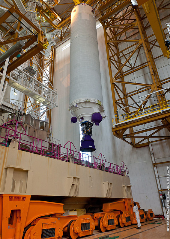 Build-up of the Ariane 5 for Flight VA210 is underway at the Spaceport, where its core cryogenic stage is shown being positioned over one of two launch tables used with Arianespace's heavy-lift workhorse. Build-up of the Ariane 5 for Flight VA210 is underway at the Spaceport, where its core cryogenic stage is shown being positioned over one of two launch tables used with Arianespace's heavy-lift workhorse.