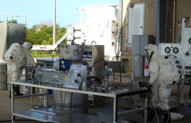 Wearing Self-Contained Atmospheric Protective Ensemble, or SCAPE, suits, technicians from Sierra Lobo conducted the first test of satellite refueling pump hardware to determine how it would perform with highly corrosive nitrogen tetroxide propellant such as that used by orbiting spacecraft. Photo credit: NASA Wearing Self-Contained Atmospheric Protective Ensemble, or SCAPE, suits, technicians from Sierra Lobo conducted the first test of satellite refueling pump hardware to determine how it would perform with highly corrosive nitrogen tetroxide propellant such as that used by orbiting spacecraft. Photo credit: NASA