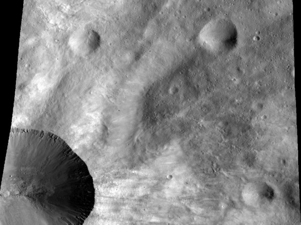 This image from NASA's Dawn spacecraft shows a close up of part of the rim around the crater Canuleia on the giant asteroid Vesta. Canuleia, about 6 miles (10 kilometers) in diameter, is the large crater at the bottom-left of this image. Image credit: NASA/JPL-Caltech/UCLA/MPS/DLR/PSI/Brown This image from NASA's Dawn spacecraft shows a close up of part of the rim around the crater Canuleia on the giant asteroid Vesta. Canuleia, about 6 miles (10 kilometers) in diameter, is the large crater at the bottom-left of this image. Image credit: NASA/JPL-Caltech/UCLA/MPS/DLR/PSI/Brown