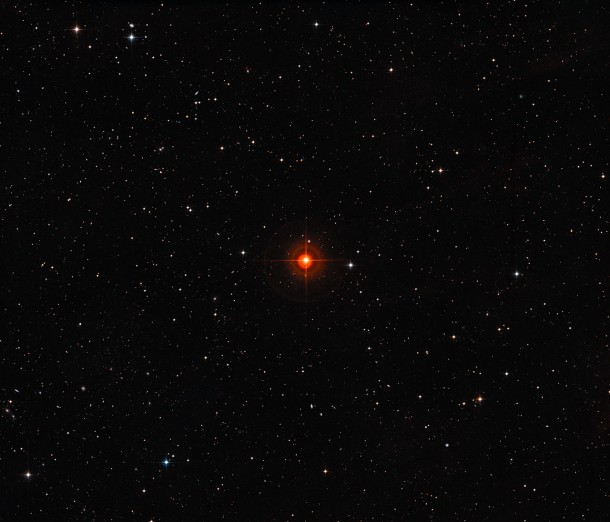 This wide-field image shows the patch of sky around the red giant variable star R Sculptoris. In this part of the sky far from the Milky Way, there are relatively few stars but many faint and distant galaxies can be seen. This view was created from photographs forming part of the Digitized Sky Survey 2. The spikes and orange circles around the star in this picture are artifacts of the telescope and photographic process and are not real. Credit: ESO/Digitized Sky Survey 2. Acknowledgement: Davide De Martin This wide-field image shows the patch of sky around the red giant variable star R Sculptoris. In this part of the sky far from the Milky Way, there are relatively few stars but many faint and distant galaxies can be seen. This view was created from photographs forming part of the Digitized Sky Survey 2. The spikes and orange circles around the star in this picture are artifacts of the telescope and photographic process and are not real. Credit: ESO/Digitized Sky Survey 2. Acknowledgement: Davide De Martin