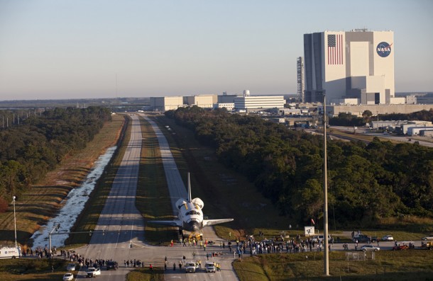 Space shuttle Atlantis moves down the Kennedy Parkway on its 76-wheeled orbiter transporter system on Friday, Nov. 2, 2012. In the background is the Vehicle Assembly Building. Image credit: NASA/Kim Shiflett Space shuttle Atlantis moves down the Kennedy Parkway on its 76-wheeled orbiter transporter system on Friday, Nov. 2, 2012. In the background is the Vehicle Assembly Building. Image credit: NASA/Kim Shiflett
