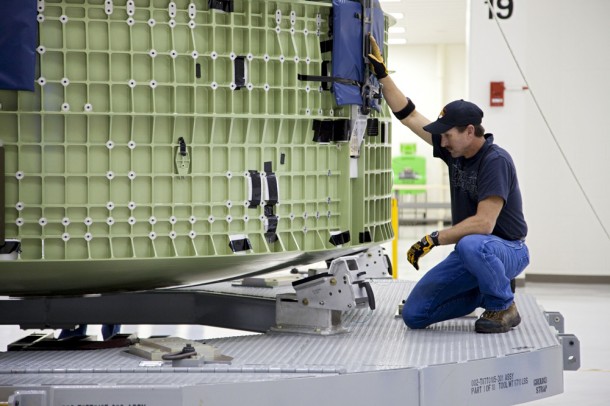 Inside the Operations and Checkout Building high bay, a technician attaches a crane to the Orion Exploration Flight Test 1 crew module so that it can be moved. Image credit: NASA/Kim Shiflett Inside the Operations and Checkout Building high bay, a technician attaches a crane to the Orion Exploration Flight Test 1 crew module so that it can be moved. Image credit: NASA/Kim Shiflett