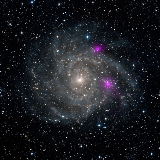 This new view of spiral galaxy IC 342, also known as Caldwell 5, includes data from NASA's Nuclear Spectroscopic Telescope Array, or NuSTAR. High-energy X-ray data from NuSTAR have been translated to the color magenta, and superimposed on a visible-light view highlighting the galaxy and its star-studded arms. NuSTAR is the first orbiting telescope to take focused pictures of the cosmos in high-energy X-ray light; previous observations of this same galaxy taken at similar wavelengths blurred the entire object into one pixel. Image credit: NASA/JPL-Caltech/DSS This new view of spiral galaxy IC 342, also known as Caldwell 5, includes data from NASA's Nuclear Spectroscopic Telescope Array, or NuSTAR. High-energy X-ray data from NuSTAR have been translated to the color magenta, and superimposed on a visible-light view highlighting the galaxy and its star-studded arms. NuSTAR is the first orbiting telescope to take focused pictures of the cosmos in high-energy X-ray light; previous observations of this same galaxy taken at similar wavelengths blurred the entire object into one pixel. Image credit: NASA/JPL-Caltech/DSS