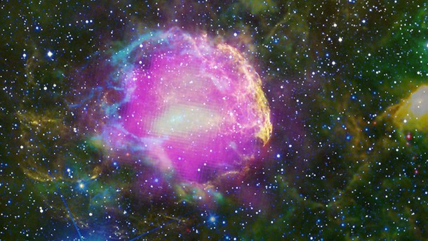 This multiwavelength composite shows the supernova remnant IC 443, also known as the Jellyfish Nebula. Fermi GeV gamma-ray emission is shown in magenta, optical wavelengths as yellow, and infrared data from NASA's Wide-field Infrared Survey Explorer (WISE) mission is shown as blue (3.4 microns), cyan (4.6 microns), green (12 microns) and red (22 microns). Cyan loops indicate where the remnant is interacting with a dense cloud of interstellar gas. Credit: NASA/DOE/Fermi LAT Collaboration, NOAO/AURA/NSF, JPL-Caltech/UCLA This multiwavelength composite shows the supernova remnant IC 443, also known as the Jellyfish Nebula. Fermi GeV gamma-ray emission is shown in magenta, optical wavelengths as yellow, and infrared data from NASA's Wide-field Infrared Survey Explorer (WISE) mission is shown as blue (3.4 microns), cyan (4.6 microns), green (12 microns) and red (22 microns). Cyan loops indicate where the remnant is interacting with a dense cloud of interstellar gas. Credit: NASA/DOE/Fermi LAT Collaboration, NOAO/AURA/NSF, JPL-Caltech/UCLA