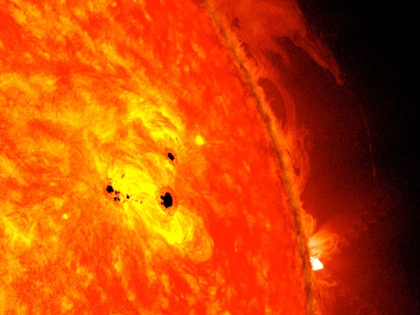 The bottom two black spots on the sun, known as sunspots, appeared quickly over the course of Feb. 19-20, 2013. These two sunspots are part of the same system and are over six Earths across. This image combines images from two instruments on NASA's Solar Dynamics Observatory (SDO): the Helioseismic and Magnetic Imager (HMI), which takes pictures in visible light that show sunspots and the Advanced Imaging Assembly (AIA), which took an image in the 304 Angstrom wavelength showing the lower atmosphere of the sun, which is colorized in red. Credit: NASA/SDO/AIA/HMI/Goddard Space Flight Center The bottom two black spots on the sun, known as sunspots, appeared quickly over the course of Feb. 19-20, 2013. These two sunspots are part of the same system and are over six Earths across. This image combines images from two instruments on NASA's Solar Dynamics Observatory (SDO): the Helioseismic and Magnetic Imager (HMI), which takes pictures in visible light that show sunspots and the Advanced Imaging Assembly (AIA), which took an image in the 304 Angstrom wavelength showing the lower atmosphere of the sun, which is colorized in red. Credit: NASA/SDO/AIA/HMI/Goddard Space Flight Center