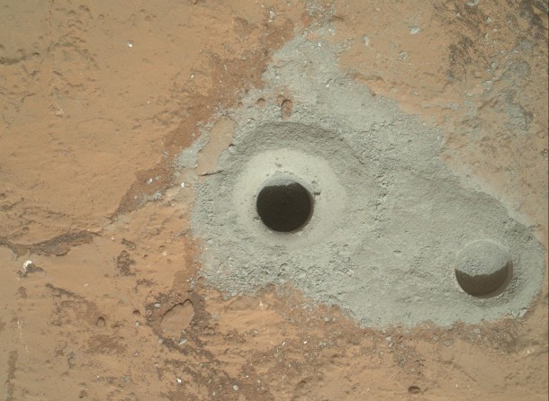 At the center of this image from NASA's Curiosity rover is the hole in a rock called "John Klein" where the rover conducted its first sample drilling on Mars. The drilling took place on Feb. 8, 2013, or Sol 182, Curiosity's 182nd Martian day of operations. Several preparatory activities with the drill preceded this operation, including a test that produced the shallower hole on the right two days earlier, but the deeper hole resulted from the first use of the drill for rock sample collection. Image credit: NASA/JPL-Caltech/MSSS At the center of this image from NASA's Curiosity rover is the hole in a rock called "John Klein" where the rover conducted its first sample drilling on Mars. The drilling took place on Feb. 8, 2013, or Sol 182, Curiosity's 182nd Martian day of operations. Several preparatory activities with the drill preceded this operation, including a test that produced the shallower hole on the right two days earlier, but the deeper hole resulted from the first use of the drill for rock sample collection. Image credit: NASA/JPL-Caltech/MSSS