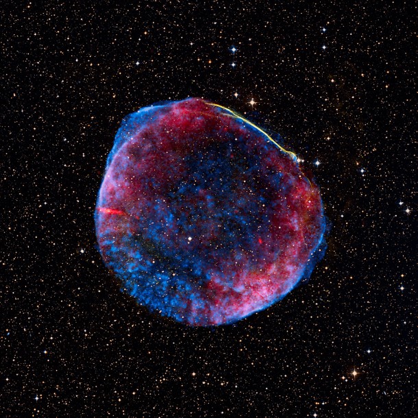 This remarkable image was created from pictures taken by different telescopes in space and on the ground. It shows the thousand-year-old remnant of the brilliant SN 1006 supernova, as seen in radio (red), X-ray (blue) and visible light (yellow). Credit: Radio: NRAO/AUI/NSF/GBT/VLA/Dyer, Maddalena & Cornwell, X-ray: Chandra X-ray Observatory; NASA/CXC/Rutgers/G. Cassam-Chenaï, J. Hughes et al., Visible light: 0.9-metre Curtis Schmidt optical telescope; NOAO/AURA/NSF/CTIO/Middlebury College/F. Winkler and Digitized Sky Survey. This remarkable image was created from pictures taken by different telescopes in space and on the ground. It shows the thousand-year-old remnant of the brilliant SN 1006 supernova, as seen in radio (red), X-ray (blue) and visible light (yellow). Credit: Radio: NRAO/AUI/NSF/GBT/VLA/Dyer, Maddalena & Cornwell, X-ray: Chandra X-ray Observatory; NASA/CXC/Rutgers/G. Cassam-Chenaï, J. Hughes et al., Visible light: 0.9-metre Curtis Schmidt optical telescope; NOAO/AURA/NSF/CTIO/Middlebury College/F. Winkler and Digitized Sky Survey.