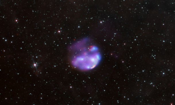 This composite of supernova remnant G306.3–0.9 merges Chandra X-ray observations (blue), infrared data acquired by the Spitzer Space Telescope (red and cyan) and radio observations (purple) from the Australia Telescope Compact Array. The image is 20 arcminutes across, which corresponds to 150 light-years at the remnant's estimated distance. Credit: X-ray: NASA/CXC/Univ. of Michigan/M. Reynolds et al; Infrared: NASA/JPL-Caltech; Radio: CSIRO/ATNF/ATCA This composite of supernova remnant G306.3–0.9 merges Chandra X-ray observations (blue), infrared data acquired by the Spitzer Space Telescope (red and cyan) and radio observations (purple) from the Australia Telescope Compact Array. The image is 20 arcminutes across, which corresponds to 150 light-years at the remnant's estimated distance. Credit: X-ray: NASA/CXC/Univ. of Michigan/M. Reynolds et al; Infrared: NASA/JPL-Caltech; Radio: CSIRO/ATNF/ATCA