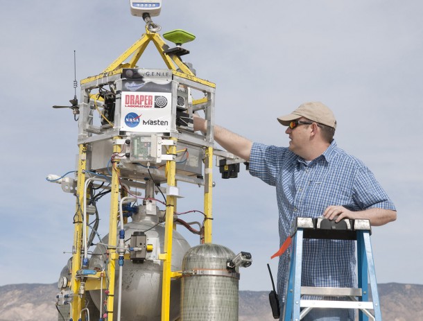 Draper Labs technician makes final adjustments to the firm's GENIE flight control system on Masten Space Systems' Xombie technology demonstration rocket before liftoff. Draper Labs technician makes final adjustments to the firm's GENIE flight control system on Masten Space Systems' Xombie technology demonstration rocket before liftoff.