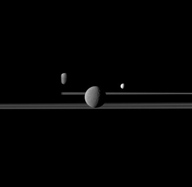 The Cassini spacecraft observes three of Saturn's moons set against the darkened night side of the planet. Image Credit: NASA/JPL/Space Science Institute The Cassini spacecraft observes three of Saturn's moons set against the darkened night side of the planet. Image Credit: NASA/JPL/Space Science Institute