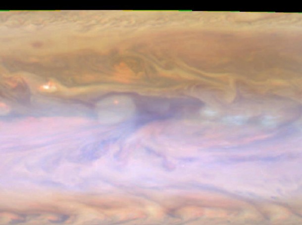 The dark hot spot in this false-color image from NASA's Cassini spacecraft is a window deep into Jupiter's atmosphere. All around it are layers of higher clouds, with colors indicating which layer of the atmosphere the clouds are in. Image credit: NASA/JPL-Caltech/SSI/GSFC The dark hot spot in this false-color image from NASA's Cassini spacecraft is a window deep into Jupiter's atmosphere. All around it are layers of higher clouds, with colors indicating which layer of the atmosphere the clouds are in. Image credit: NASA/JPL-Caltech/SSI/GSFC
