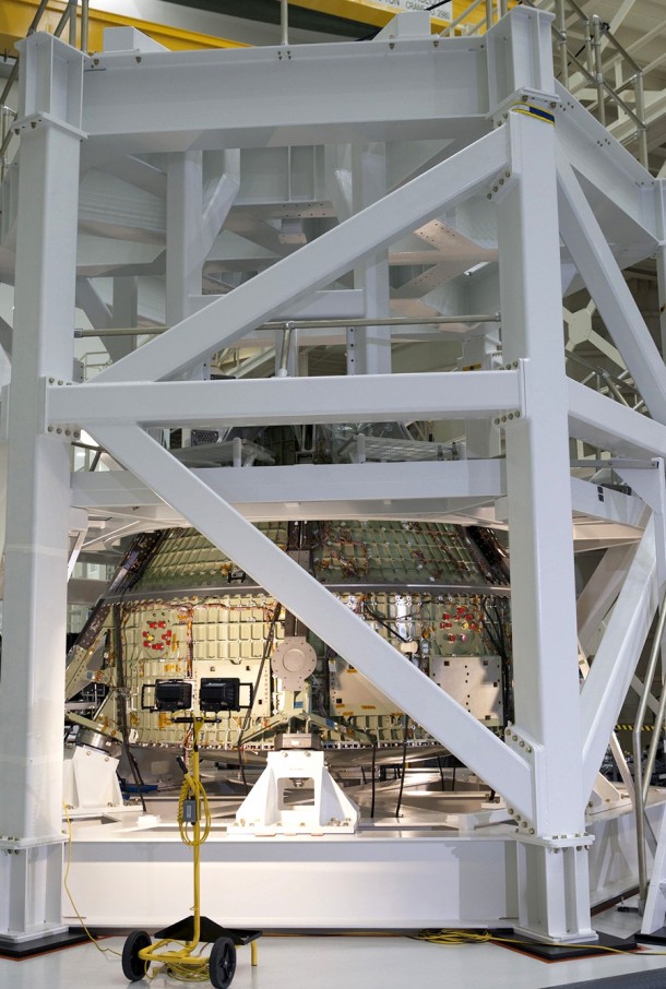 In the Operations and Checkout Building at the Kennedy Space Center, the Orion crew module is secured on the static load test fixture in preparation for a series of tests that will simulate the massive loads the spacecraft would experience during its mission. Photo credit: NASA/Kim Shiflett In the Operations and Checkout Building at the Kennedy Space Center, the Orion crew module is secured on the static load test fixture in preparation for a series of tests that will simulate the massive loads the spacecraft would experience during its mission. Photo credit: NASA/Kim Shiflett
