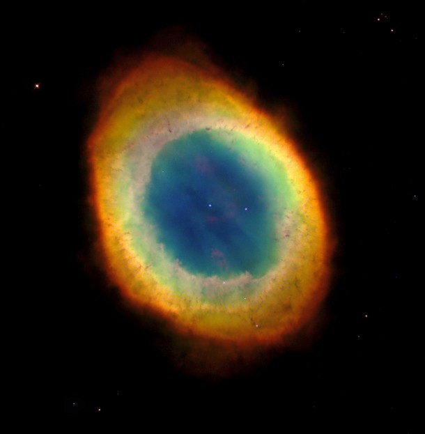 This planetary nebula's simple, graceful appearance is thought to be due to perspective: our view from Earth looking straight into what is actually a barrel-shaped cloud of gas shrugged off by a dying central star. Hot blue gas near the energizing central star gives way to progressively cooler green and yellow gas at greater distances with the coolest red gas along the outer boundary. Credit: NASA/Hubble Heritage Team This planetary nebula's simple, graceful appearance is thought to be due to perspective: our view from Earth looking straight into what is actually a barrel-shaped cloud of gas shrugged off by a dying central star. Hot blue gas near the energizing central star gives way to progressively cooler green and yellow gas at greater distances with the coolest red gas along the outer boundary. Credit: NASA/Hubble Heritage Team