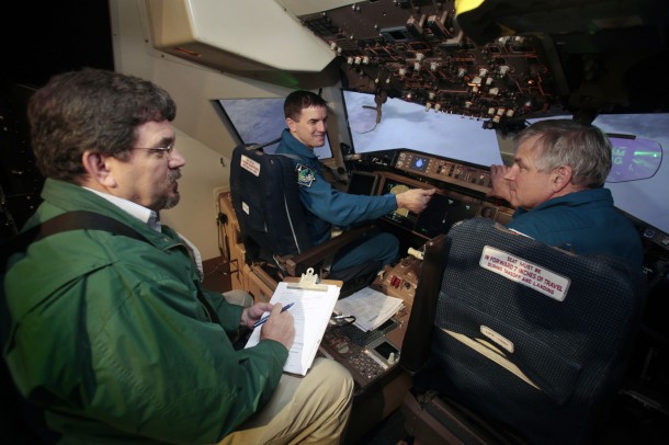 Bruce Jackson, an aerospace engineer at NASA’s Langley Flight Research Center, briefs astronauts Rex Walheim, left, and Gregory Johnson as they evaluate Sierra Nevada Corporation's Dream Chaser landing simulation in the Cockpit Motion Facility. Image credit: NASA/David C. Bowman Bruce Jackson, an aerospace engineer at NASA’s Langley Flight Research Center, briefs astronauts Rex Walheim, left, and Gregory Johnson as they evaluate Sierra Nevada Corporation's Dream Chaser landing simulation in the Cockpit Motion Facility. Image credit: NASA/David C. Bowman