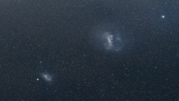 This visible light mosaic shows the Large Magellanic Cloud and Small Magellanic Cloud. Separated by about 21 degrees, the two galaxies are readily visible from the Southern Hemisphere as faint, glowing patches in the night sky. The LMC and SMC are the closest major galaxies to our own and lie about 163,000 and 200,000 light-years away, respectively. Credit: Axel Mellinger, Central Michigan Univ. This visible light mosaic shows the Large Magellanic Cloud and Small Magellanic Cloud. Separated by about 21 degrees, the two galaxies are readily visible from the Southern Hemisphere as faint, glowing patches in the night sky. The LMC and SMC are the closest major galaxies to our own and lie about 163,000 and 200,000 light-years away, respectively. Credit: Axel Mellinger, Central Michigan Univ.