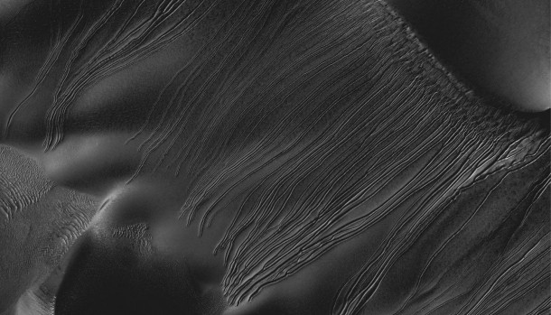 Several types of downhill flow features have been observed on Mars. This image from the High Resolution Imaging Science Experiment (HiRISE) camera on NASA's Mars Reconnaissance Orbiter is an example of a type called "linear gullies." Image credit: NASA/JPL-Caltech/Univ. of Arizona Several types of downhill flow features have been observed on Mars. This image from the High Resolution Imaging Science Experiment (HiRISE) camera on NASA's Mars Reconnaissance Orbiter is an example of a type called "linear gullies." Image credit: NASA/JPL-Caltech/Univ. of Arizona