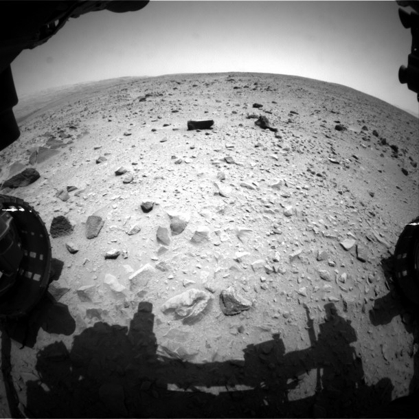 NASA's Curiosity Mars rover captured this image with its left front Hazard-Avoidance Camera (Hazcam) just after completing a drive that took the mission's total driving distance past the 1 kilometer (0.62 mile) mark. The image was taken on July 16, 2013, during the afternoon of 335th Martian day, or sol, of Curiosity's work on Mars. The view is in the direction of the next planned drive, toward the southwest. Portions of the rover's left and right front wheels are visible at the sides of the scene. Image credit: NASA/JPL-Caltech NASA's Curiosity Mars rover captured this image with its left front Hazard-Avoidance Camera (Hazcam) just after completing a drive that took the mission's total driving distance past the 1 kilometer (0.62 mile) mark. The image was taken on July 16, 2013, during the afternoon of 335th Martian day, or sol, of Curiosity's work on Mars. The view is in the direction of the next planned drive, toward the southwest. Portions of the rover's left and right front wheels are visible at the sides of the scene. Image credit: NASA/JPL-Caltech