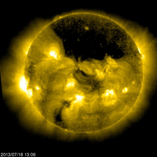 The European Space Agency/NASA Solar and Heliospheric Observatory, or SOHO, captured this image of a gigantic coronal hole hovering over the sun’s north pole on July 18, 2013, at 9:06 a.m. EDT. Image Credit: ESA&NASA/SOHO The European Space Agency/NASA Solar and Heliospheric Observatory, or SOHO, captured this image of a gigantic coronal hole hovering over the sun’s north pole on July 18, 2013, at 9:06 a.m. EDT. Image Credit: ESA&NASA/SOHO