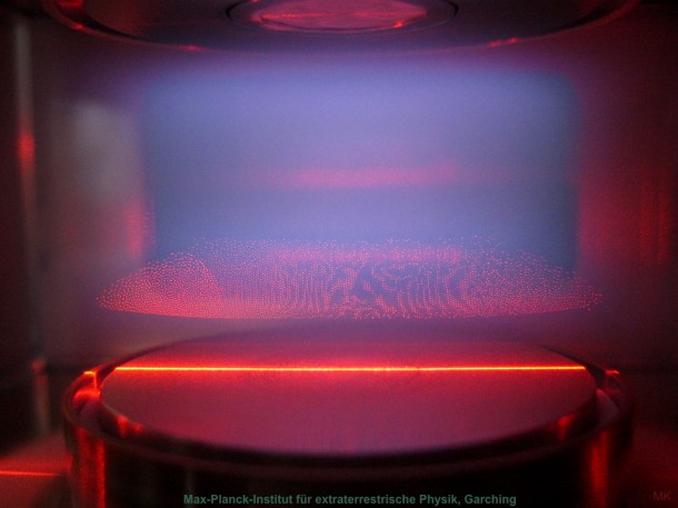 Side view of a plasma crystal in the laboratory. Dust particles are suspended in an argon plasma above a high-frequency electrode (bottom). The horizontal field of view is 2 cm. Image Credit: Max Planck Institute for Extraterrestrial Physics Side view of a plasma crystal in the laboratory. Dust particles are suspended in an argon plasma above a high-frequency electrode (bottom). The horizontal field of view is 2 cm. Image Credit: Max Planck Institute for Extraterrestrial Physics
