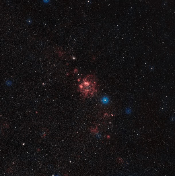 This wide field view of part of the Large Magellanic Cloud includes the location of the N11 star formation region. This image was created from digitised photographs through red and blue filters. The field of view is about three degrees across. Credit: ESO/Digitized Sky Survey 2. Acknowledgment: Davide De Martin This wide field view of part of the Large Magellanic Cloud includes the location of the N11 star formation region. This image was created from digitised photographs through red and blue filters. The field of view is about three degrees across. Credit: ESO/Digitized Sky Survey 2. Acknowledgment: Davide De Martin
