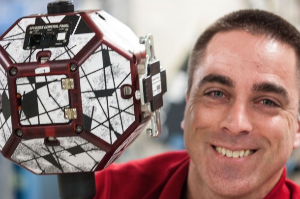 In the International Space Station's Kibo laboratory, Flight Engineer Chris Cassidy poses for a photo while conducting a session with a pair of bowling-ball-sized free-flying satellites known as Synchronized Position Hold, Engage, Reorient, Experimental Satellites, or SPHERES. Image Credit: NASA In the International Space Station's Kibo laboratory, Flight Engineer Chris Cassidy poses for a photo while conducting a session with a pair of bowling-ball-sized free-flying satellites known as Synchronized Position Hold, Engage, Reorient, Experimental Satellites, or SPHERES. Image Credit: NASA