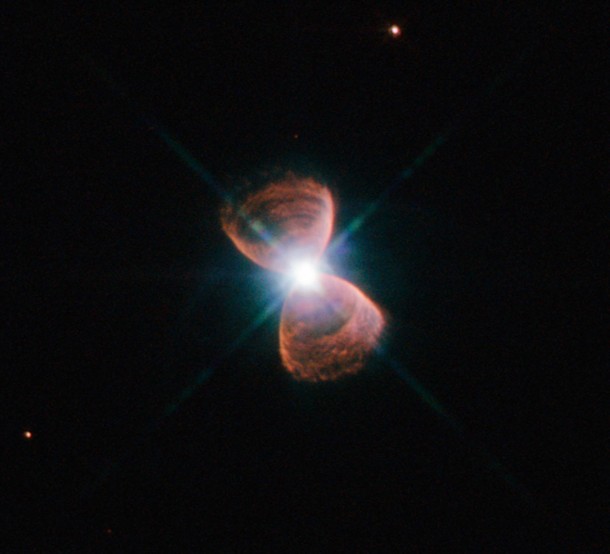 This image taken with the NASA/ESA Hubble Space Telescope shows an example of a bipolar planetary nebula. This object, which is known as Hubble 12 and also catalogued as PN G111.8-02.8, lies in the constellation of Cassiopeia. The striking shape of Hubble 12, reminiscent of a butterfly or an hourglass, was formed as a Sun-like star approached the end of its life and puffed its outer layers into the surrounding space. For bipolar nebulae, this material is funnelled towards the poles of the ageing star, creating the distinctive double-lobed structure. Credit: NASA, ESA Acknowledgement: Josh Barrington This image taken with the NASA/ESA Hubble Space Telescope shows an example of a bipolar planetary nebula. This object, which is known as Hubble 12 and also catalogued as PN G111.8-02.8, lies in the constellation of Cassiopeia. The striking shape of Hubble 12, reminiscent of a butterfly or an hourglass, was formed as a Sun-like star approached the end of its life and puffed its outer layers into the surrounding space. For bipolar nebulae, this material is funnelled towards the poles of the ageing star, creating the distinctive double-lobed structure. Credit: NASA, ESA Acknowledgement: Josh Barrington