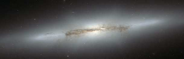 This image from the NASA/ESA Hubble Space Telescope shows edge-on galaxy NGC 4710. When staring directly at the centre of the galaxy, one can detect a faint, ethereal "X"-shaped structure. Such a feature, which astronomers call a "boxy" or "peanut-shaped" bulge, is due to the vertical motions of the stars in the galaxy's bar and is only evident when the galaxy is seen edge-on. This curious feature is also seen in the Milky Way. Credit: NASA & ESA This image from the NASA/ESA Hubble Space Telescope shows edge-on galaxy NGC 4710. When staring directly at the centre of the galaxy, one can detect a faint, ethereal "X"-shaped structure. Such a feature, which astronomers call a "boxy" or "peanut-shaped" bulge, is due to the vertical motions of the stars in the galaxy's bar and is only evident when the galaxy is seen edge-on. This curious feature is also seen in the Milky Way. Credit: NASA & ESA