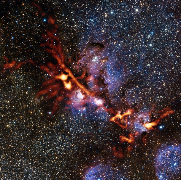 This image of the star formation region NGC 6334 is one of the first scientific images from the ArTeMiS instrument on APEX. The picture shows the glow detected at a wavelength of 0.35 millimetres coming from dense clouds of interstellar dust grains. The new observations from ArTeMiS show up in orange and have been superimposed on a view of the same region taken in near-infrared light by ESO’s VISTA telescope at Paranal. Credit: ArTeMiS team/Ph. André, M. Hennemann, V. Revéret et al./ESO/J. Emerson/VISTA Acknowledgment: Cambridge Astronomical Survey Unit This image of the star formation region NGC 6334 is one of the first scientific images from the ArTeMiS instrument on APEX. The picture shows the glow detected at a wavelength of 0.35 millimetres coming from dense clouds of interstellar dust grains. The new observations from ArTeMiS show up in orange and have been superimposed on a view of the same region taken in near-infrared light by ESO’s VISTA telescope at Paranal. Credit: ArTeMiS team/Ph. André, M. Hennemann, V. Revéret et al./ESO/J. Emerson/VISTA Acknowledgment: Cambridge Astronomical Survey Unit
