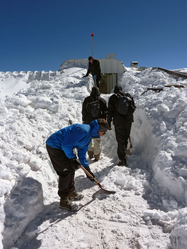 The ArTeMiS team shovel snow to get into the APEX control building on the Chajnantor Plateau in northern Chile. In the foreground is Laurent Clerc, in the middle are Jérôme Martignac (left) and François Visticot (right), and in the background by the door to the building is Yannick Le Pennec. Credit: ArTeMiS team/ESO The ArTeMiS team shovel snow to get into the APEX control building on the Chajnantor Plateau in northern Chile. In the foreground is Laurent Clerc, in the middle are Jérôme Martignac (left) and François Visticot (right), and in the background by the door to the building is Yannick Le Pennec. Credit: ArTeMiS team/ESO