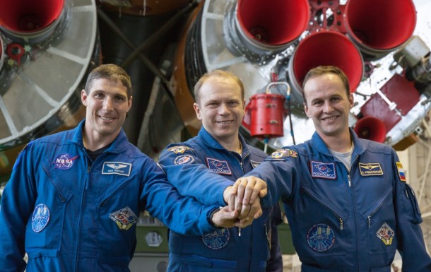Expedition 37/38 Flight Engineer Michael Hopkins of NASA (left), Soyuz Commander Oleg Kotov (center) and Flight Engineer Sergey Ryazanskiy stand in front of their Soyuz booster rocket. Image Credit: NASA/Victor Zelentsov Expedition 37/38 Flight Engineer Michael Hopkins of NASA (left), Soyuz Commander Oleg Kotov (center) and Flight Engineer Sergey Ryazanskiy stand in front of their Soyuz booster rocket. Image Credit: NASA/Victor Zelentsov